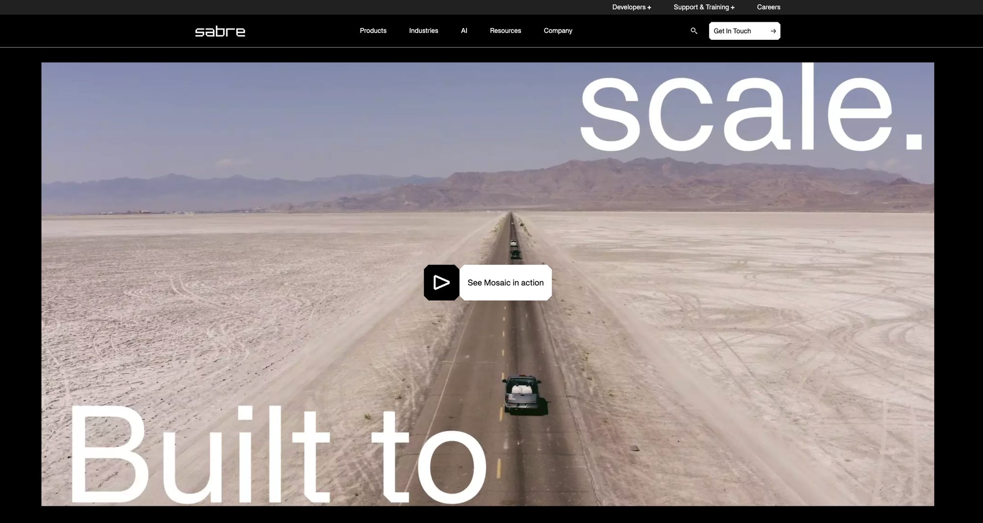 The launched Sabre homepage: a cinematic, brand-led hero reading 'Built to scale' over a car on an open desert road.